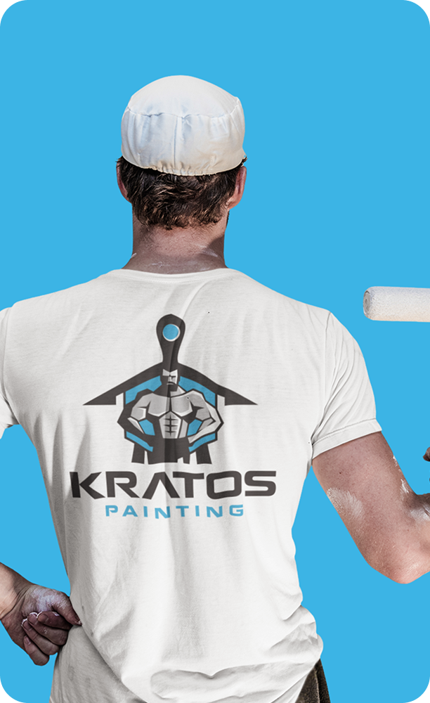 Kratos Painting professional wearing a branded shirt and holding a paint brush