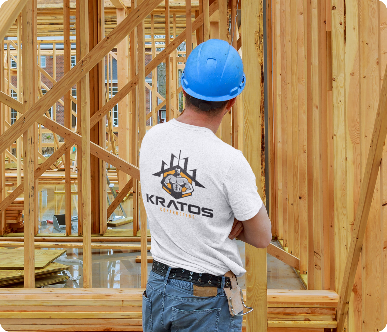 A Kratos Contracting supervisor standing in front of a residential house under construction, performing a quality control inspection.